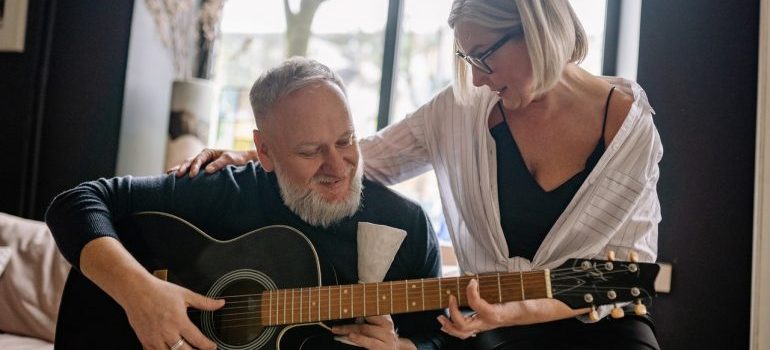 Two people play guitar enjoying Boise as a senior.