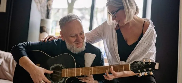 Two people play guitar enjoying Boise as a senior.