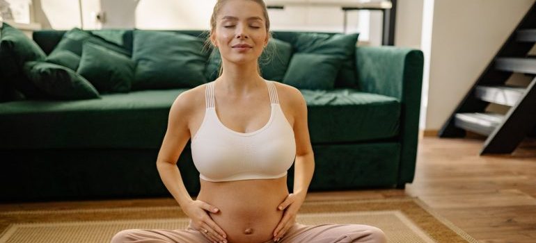 A pregnant woman does yoga.