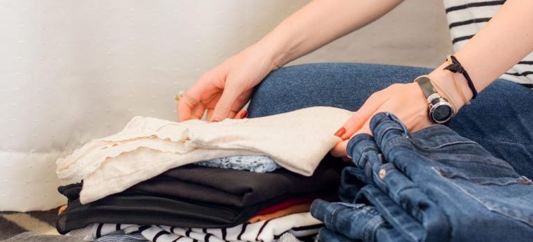 person folding clothes