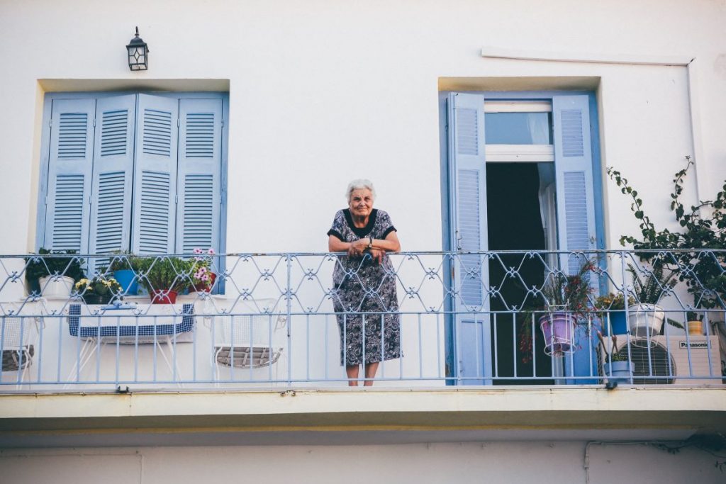 an older person looking from a terrace