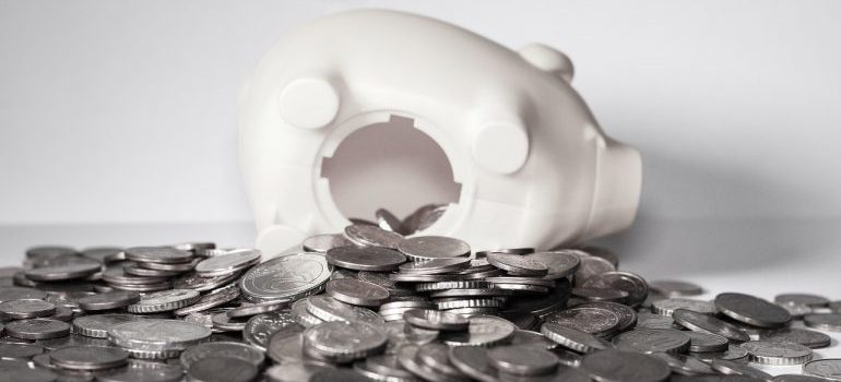 Coins spilling out of a piggy bank.