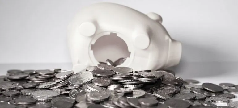 Coins spilling out of a piggy bank.