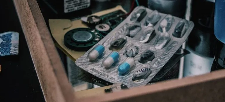 almost expired pills, representing what not to pack when packing your medicine cabinet