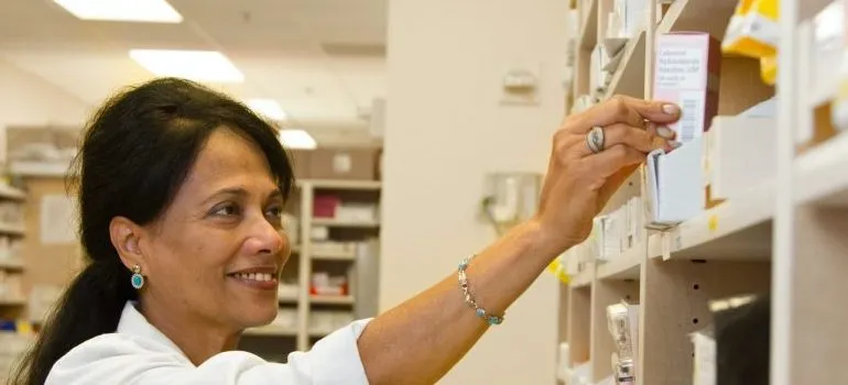 person categorizing medicine