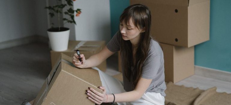 person labeling a box