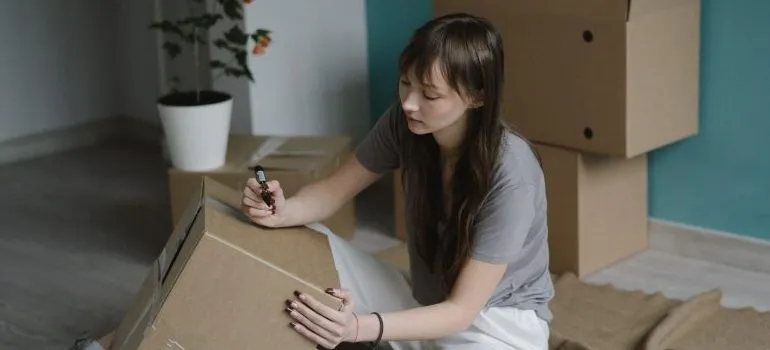 person labeling a box