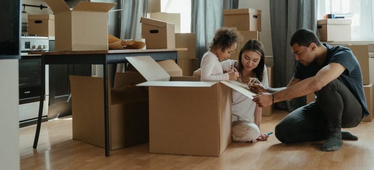A happy family unpacking boxes