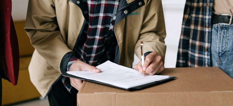 person signing a document