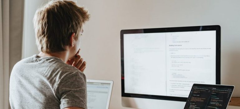 man looking at code on the screen