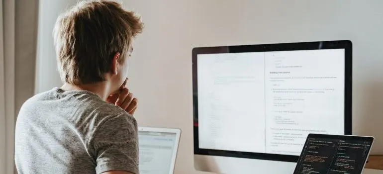 man looking at code on the screen