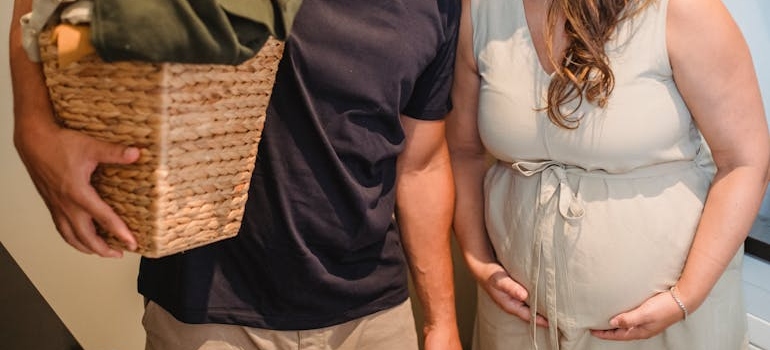 Faceless couple kissing while standing at home