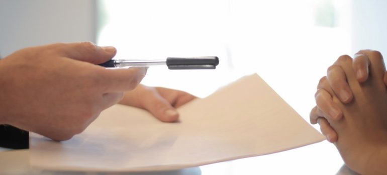 person offering a clear contract as a way of prevent misunderstandings with movers