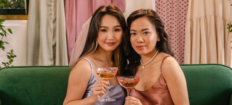 two people holding a wine glass each