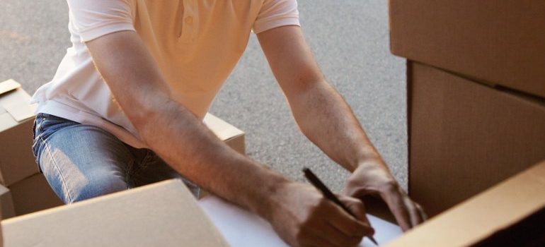 person amid moving boxes