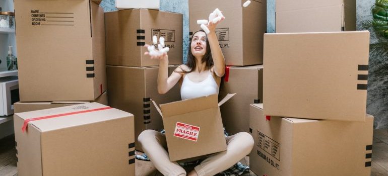 woman packing a cardboard box