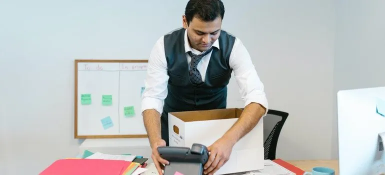 A man packing his office desk.