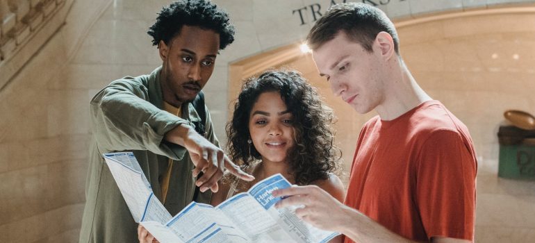 three people looking at a map of the city