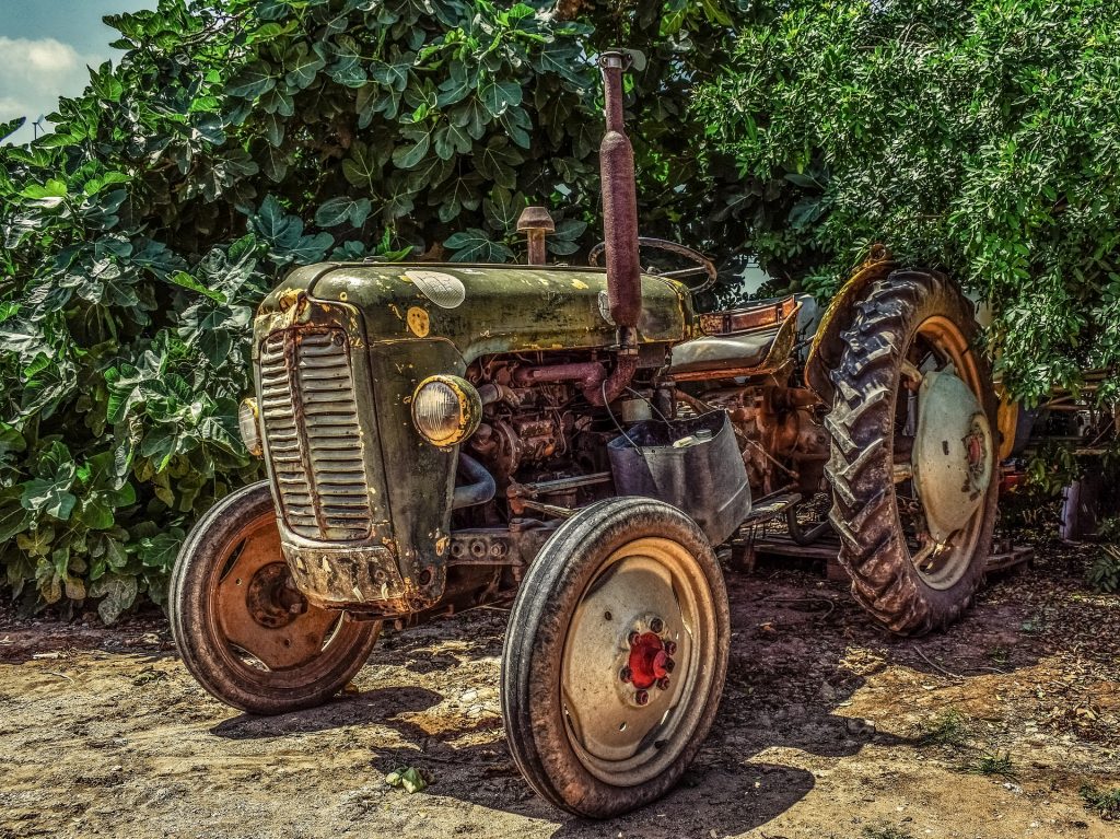 a dirty tractor, showing the need to clean and store agricultural equipment