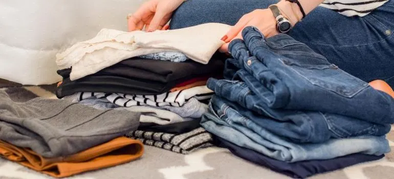 person using decluttering techniques to pack