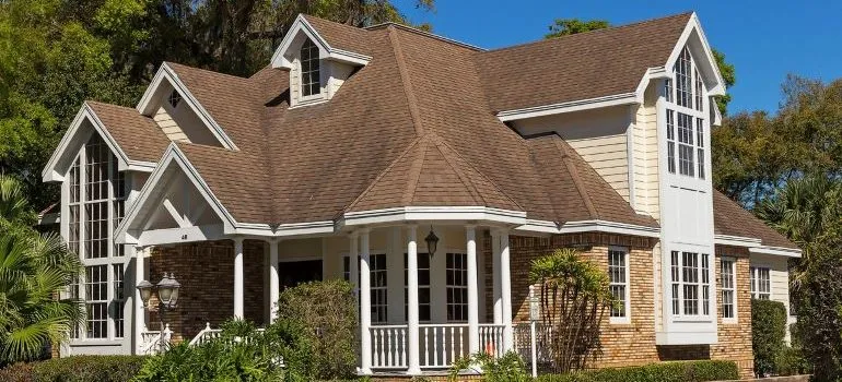 beige home with a brown roof