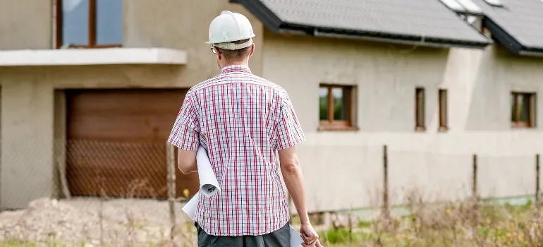 an engineer moving toward a house