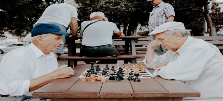Two seniors playing chess outdoors