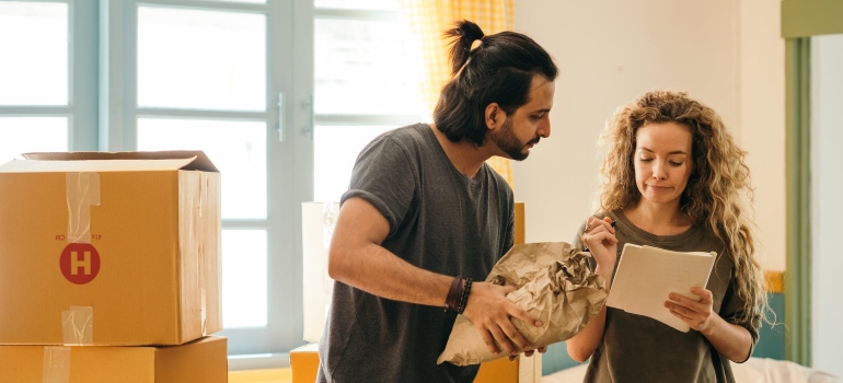 couple packing and talking about how to execute a fast and silent move