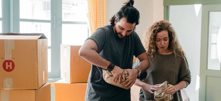 a couple packing for a move