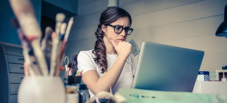 A girl looking at a lap top