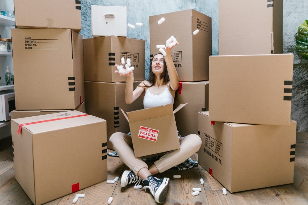 girl surrounded with moving boxes