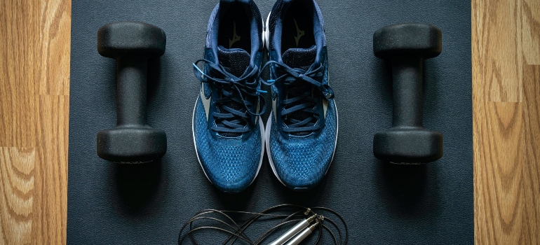 A man getting ready for storing workout equipment
