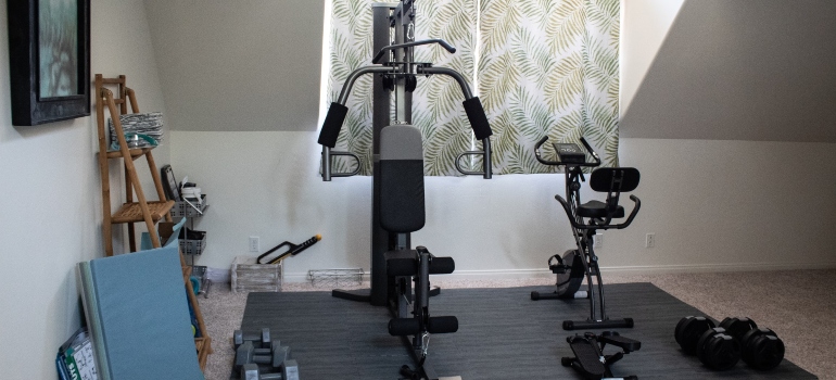 someone storing workout equipment in the attic