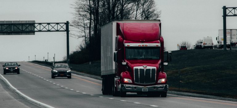 red truck driving down the highway