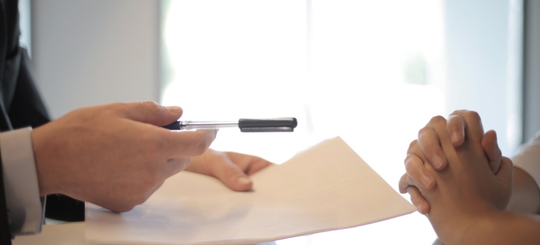 A man signing a documets