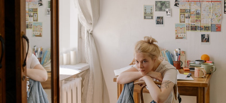 girl sitting and thinking how to pack a dresser