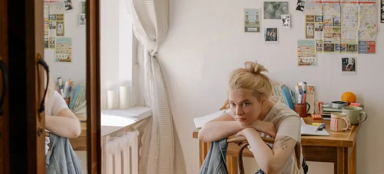 girl sitting and thinking how to pack a dresser