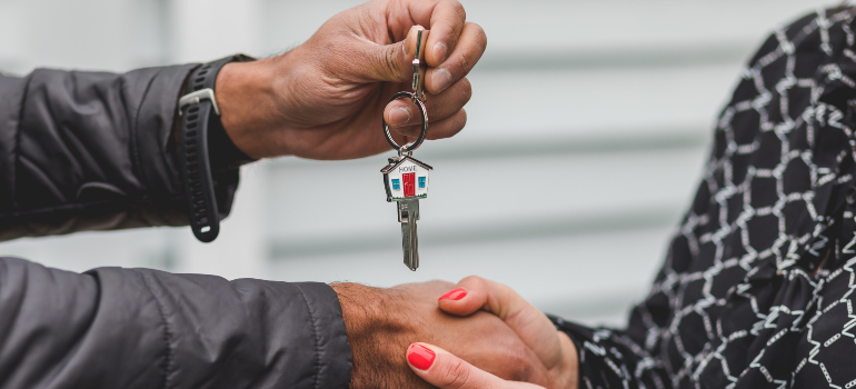 man giving a woman a house key