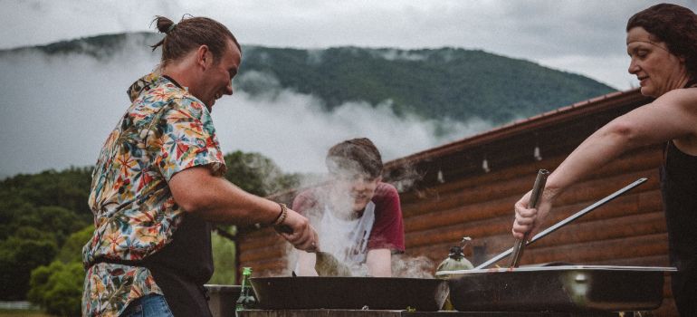 man cooking barbecue in order to establish himself in a new community