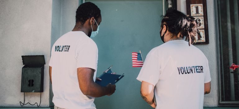 two people volunteering in their neighborhood