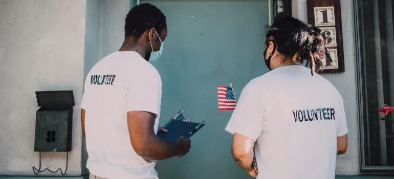 two people volunteering in their neighborhood