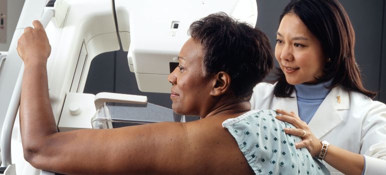 woman getting examined by a doctor before moving while injured