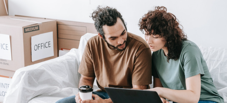 two people reading on a laptop about benefits of self storage for couples