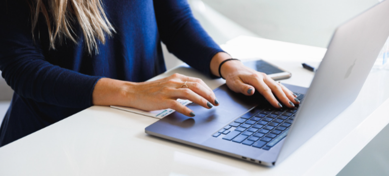 woman typing on a laptop keyboard