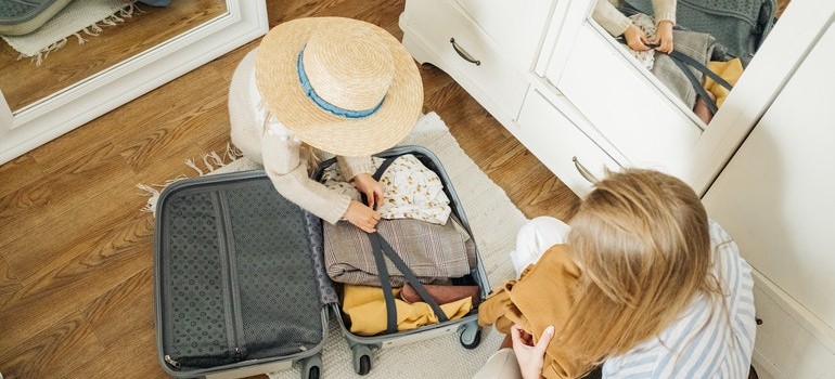 Mother and daughter packing a bag
