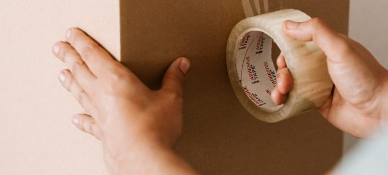 man packing a box