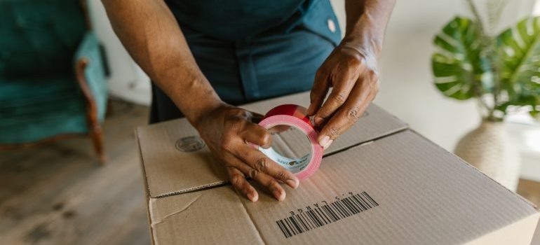 man packing a box