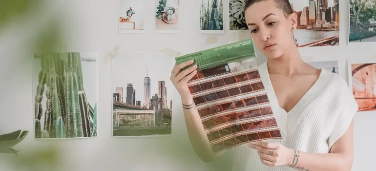 a woman looking at photo negatives 