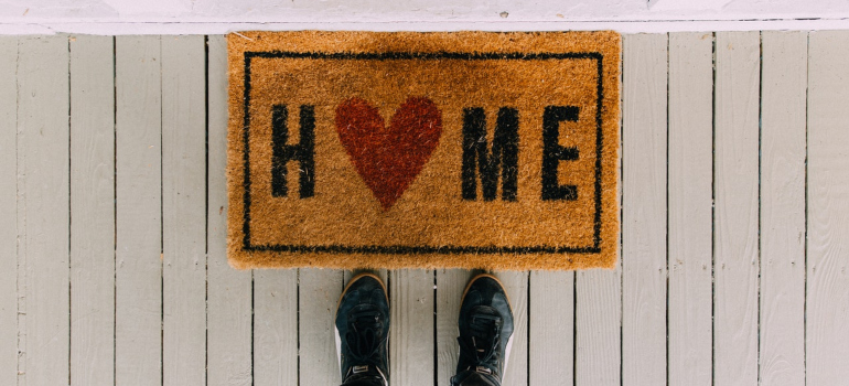 standing in front of a door mat