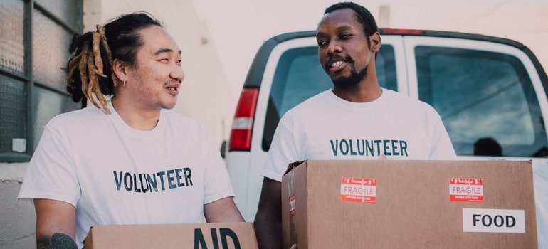 two men holding boxes